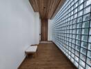 Hallway with wooden flooring, glass block wall, and wooden ceiling