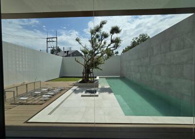 Modern outdoor area with a minimalist pool and seating area