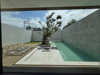 Modern outdoor area with a minimalist pool and seating area