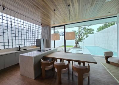 Modern kitchen with dining area and view of outdoor pool