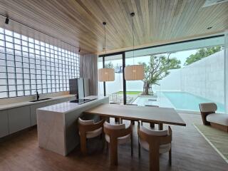 Modern kitchen with dining area and view of outdoor pool