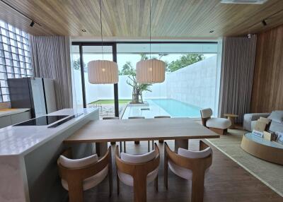 Modern kitchen and dining area with a view of the swimming pool