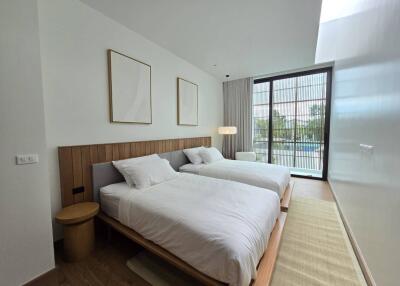 Modern bedroom with two beds and large window