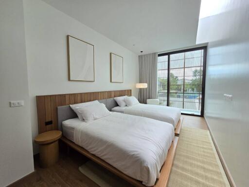 Modern bedroom with two beds and large window