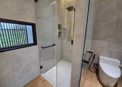 Modern bathroom with enclosed shower and toilet