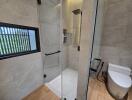 Modern bathroom with enclosed shower and toilet