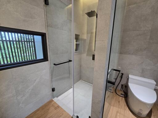 Modern bathroom with enclosed shower and toilet