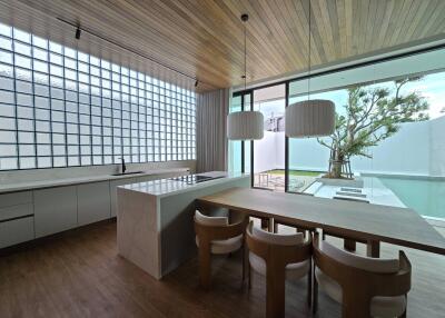 Modern kitchen with dining area and large glass windows