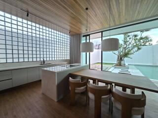 Modern kitchen with dining area and large glass windows