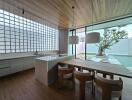 Modern kitchen with dining area and large glass windows