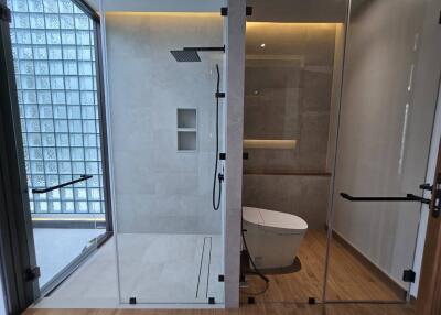 Modern bathroom with glass shower and toilet