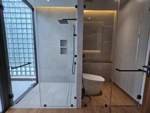 Modern bathroom with glass shower and toilet