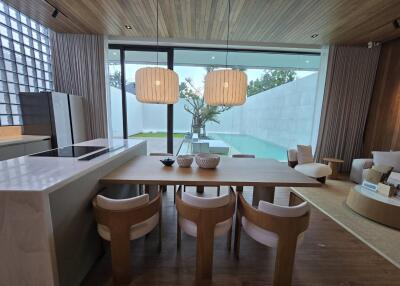 Kitchen and dining area with a view of the pool and garden