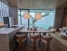 Kitchen and dining area with a view of the pool and garden