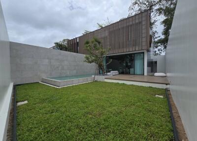 Modern backyard with pool and green lawn