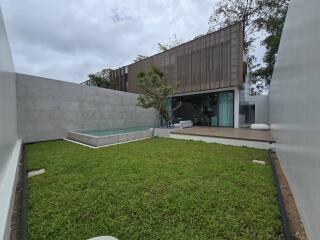 Modern backyard with pool and green lawn