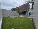 Modern backyard with pool and green lawn