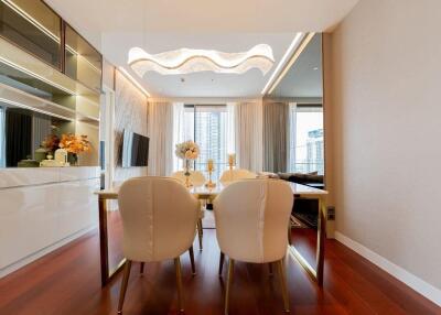 Modern dining area with a table and chairs near large windows