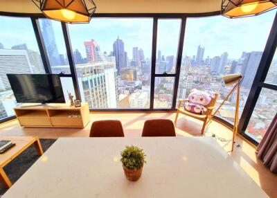 Spacious living room with large windows and city view