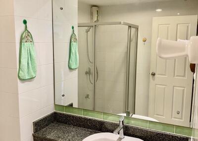 Modern bathroom with a large mirror and shower