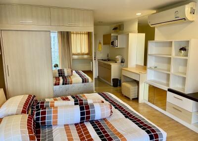 Well-furnished bedroom with study area and kitchenette