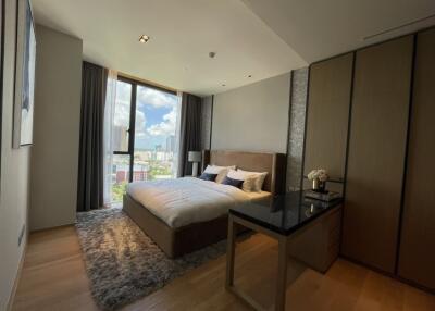 Modern bedroom with large window and city view