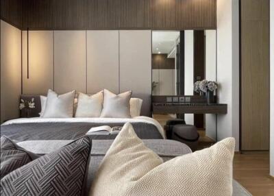 Modern bedroom with gray and white color scheme, decorative pillows, and built-in mirror on the wall