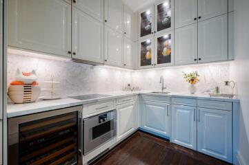 Modern kitchen with white cabinets and appliances