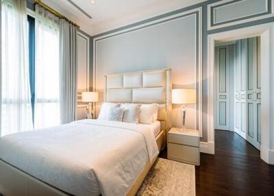 Bright and elegantly decorated bedroom with a bed, side tables, and floor lamps