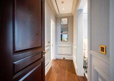 Elegant hallway with wooden flooring and wainscoting