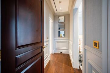 Elegant hallway with wooden flooring and wainscoting