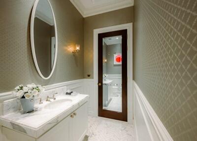 Elegant bathroom with marble sink and oval mirror