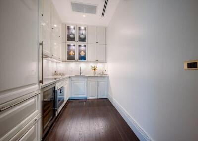 Modern kitchen with white cabinets and stainless steel appliances