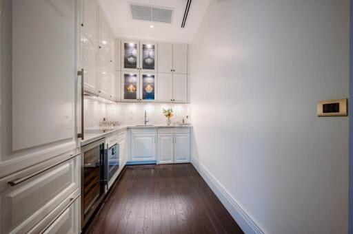 Modern kitchen with white cabinets and stainless steel appliances