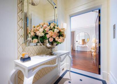 Elegant hallway entrance with decorative flowers and mirror