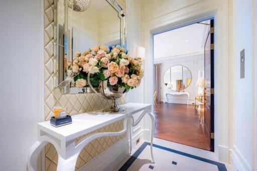 Elegant hallway entrance with decorative flowers and mirror