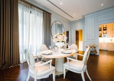 Elegant dining area with round table and chairs near large window