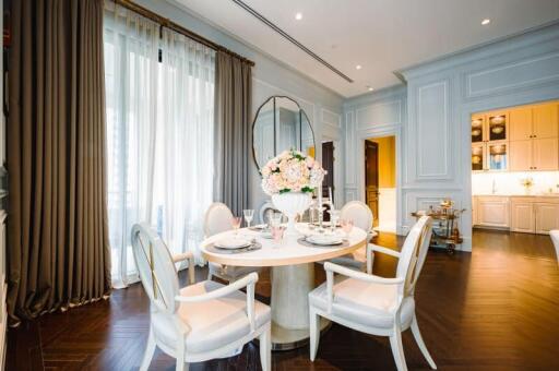 Elegant dining area with round table and chairs near large window