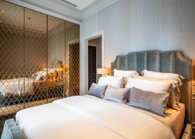 Luxurious bedroom with mirrored wardrobe and cushioned headboard