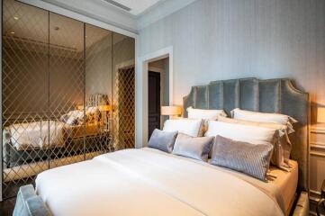 Luxurious bedroom with mirrored wardrobe and cushioned headboard