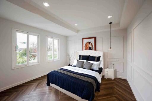 Modern bedroom with large windows and stylish decor