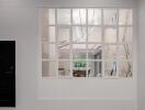 View of interior space through window with decorative lamp and seating area