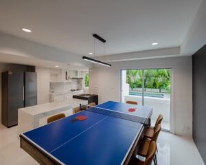 Modern kitchen with dining area and indoor table tennis setup