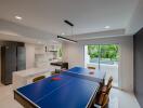 Modern kitchen with dining area and indoor table tennis setup