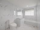 Modern white marble bathroom with built-in bathtub, toilet, modern sink, and large window blocks