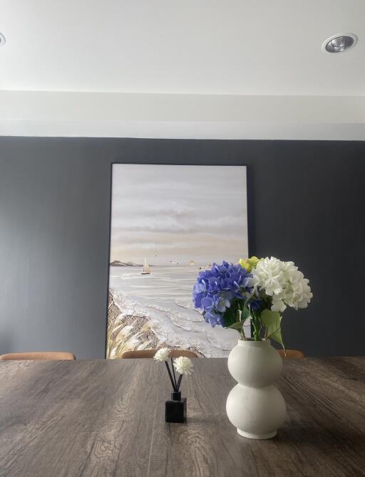 Modern dining space with flowers and wall art