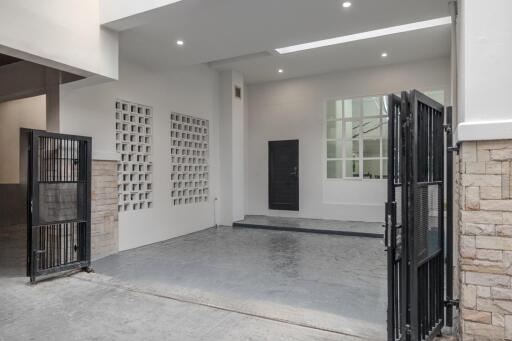 Modern garage with tiled floor and gated entry