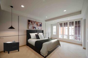 Spacious modern bedroom with large windows