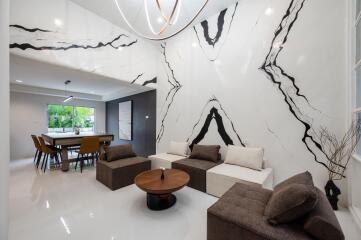 Modern living and dining area with unique wall art and contemporary furniture