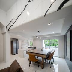 Modern kitchen and dining area with large table and sleek design